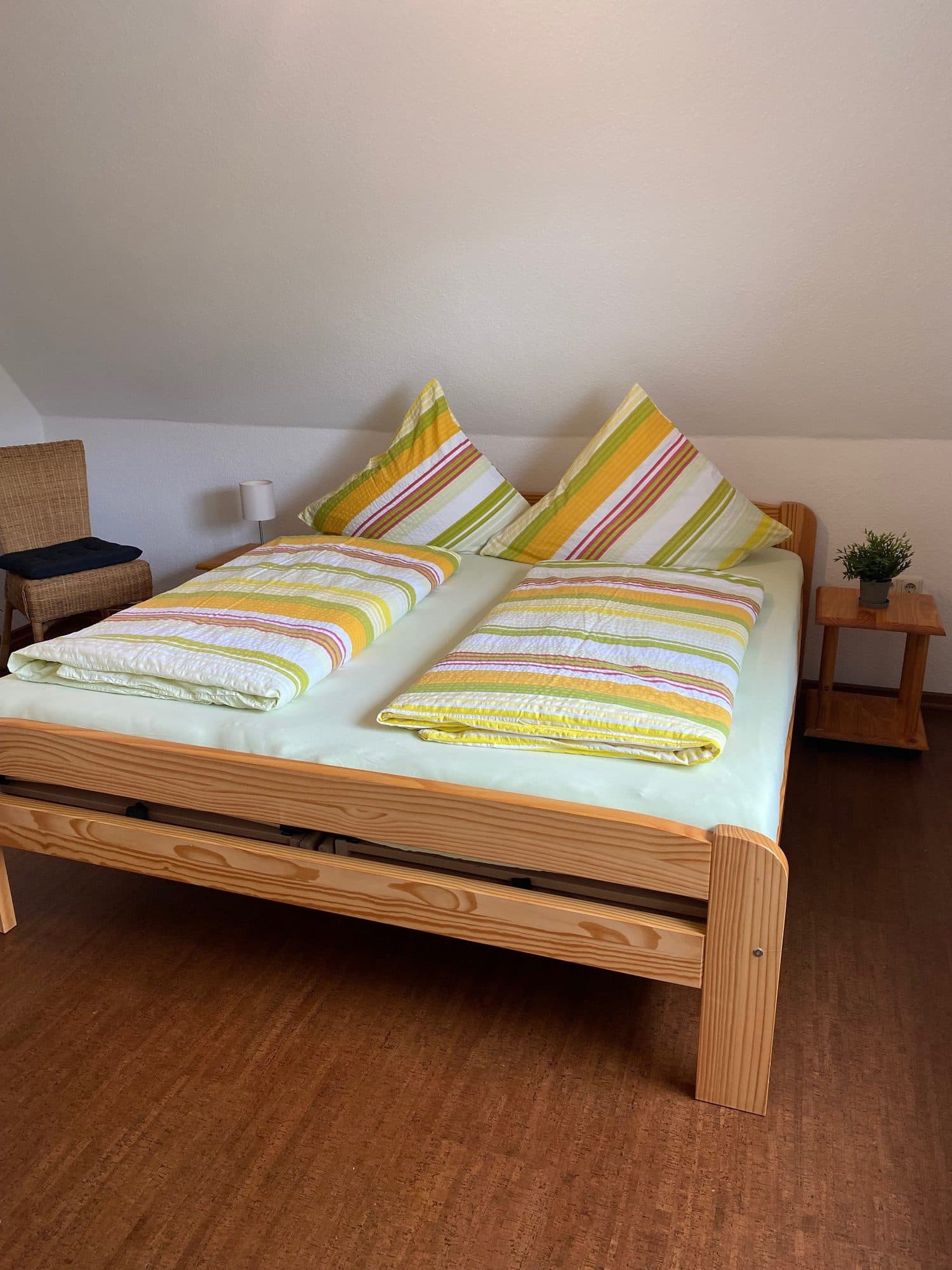 Schlafzimmer mit Doppelbett und gestreifter Bettwäsche